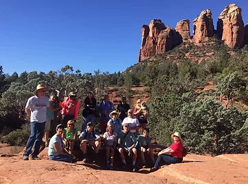 Trekabout group with unique cliffs in background