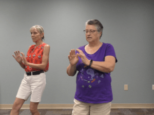 Two women performing Tai Chi