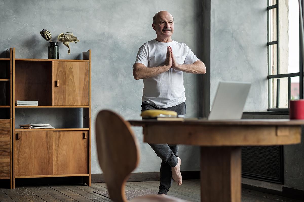 Senior hispanic man standing in one leg yoga balance. Healthy lifestyle at old age