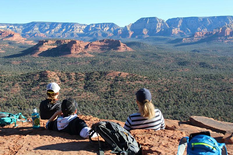 Mountains in background as hikers take in the beautiful view